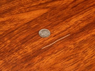 A scratched wood floor surface.