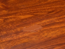 FloorFil laminate floor repair/filler has been applied to a scratched floor surface.