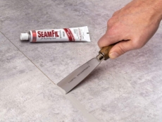 Applying SeamFil with a putty knife.