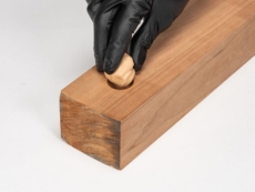 A person applies WoodFil EPOXY putty.