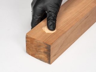 A person fills a hole with WoodFil EPOXY.